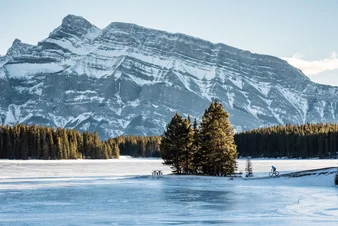 Shot of Two Jack Lake in the Canadian Rockies during winter, a place that people can experience when traveling to the Rockies by train.
