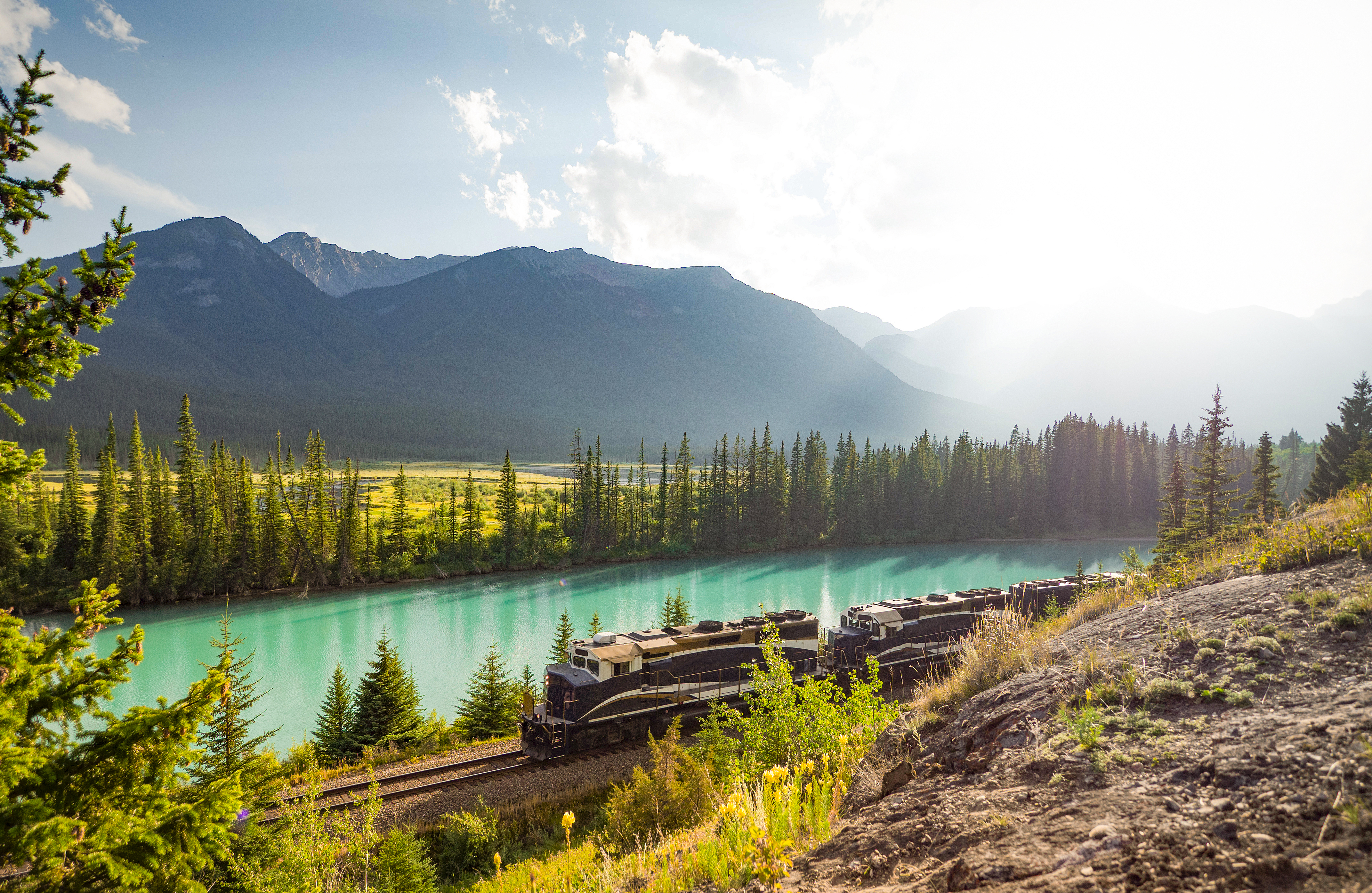 Rocky Mountaineer train alongside a lake in the Canadian Rocky Mountains