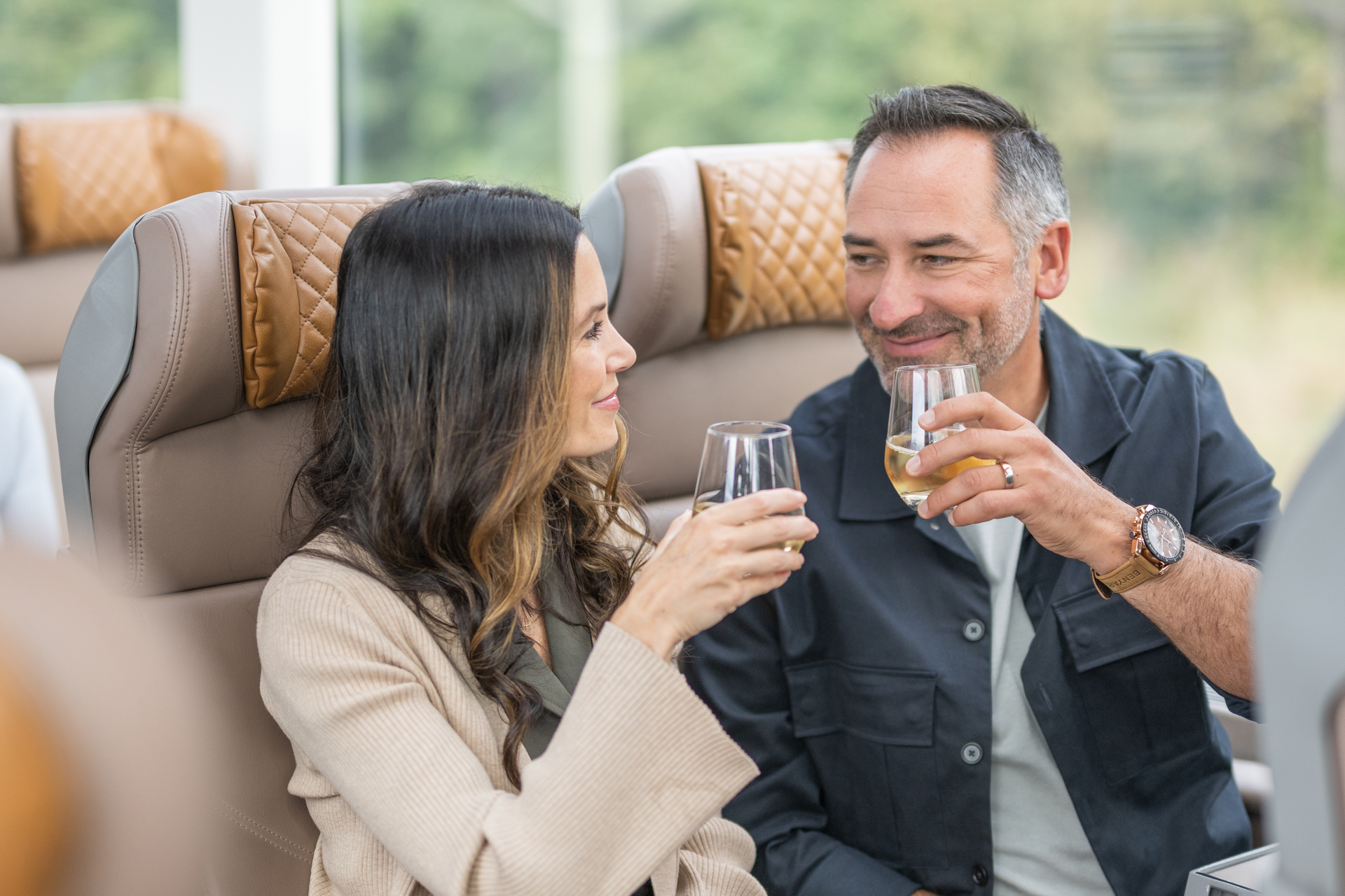 Guests drinking wine in their seats in GoldLeaf on the Rocky Mountaineer Train