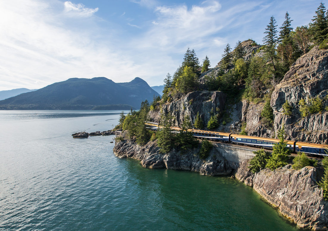 The Rocky Mountaineer Train travels along the ocean on the Sea to Sky