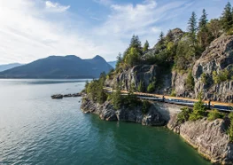 The Rocky Mountaineer Train travels along the ocean on the Sea to Sky