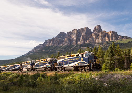The Rocky Mountaineer train passing by Castle Mounain in the Canadian Rockies