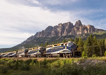 The Rocky Mountaineer train passing by Castle Mounain in the Canadian Rockies