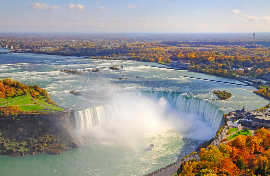 High-angle view of Canadian Niagara Falls with fall foliage. 