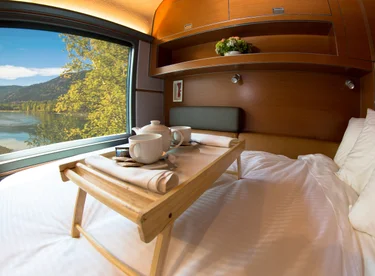 Plush bed facing train window in VIA Rail Prestige cabin for two