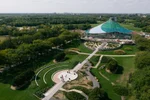 Aerial shot of a modern building and surrounding gardens