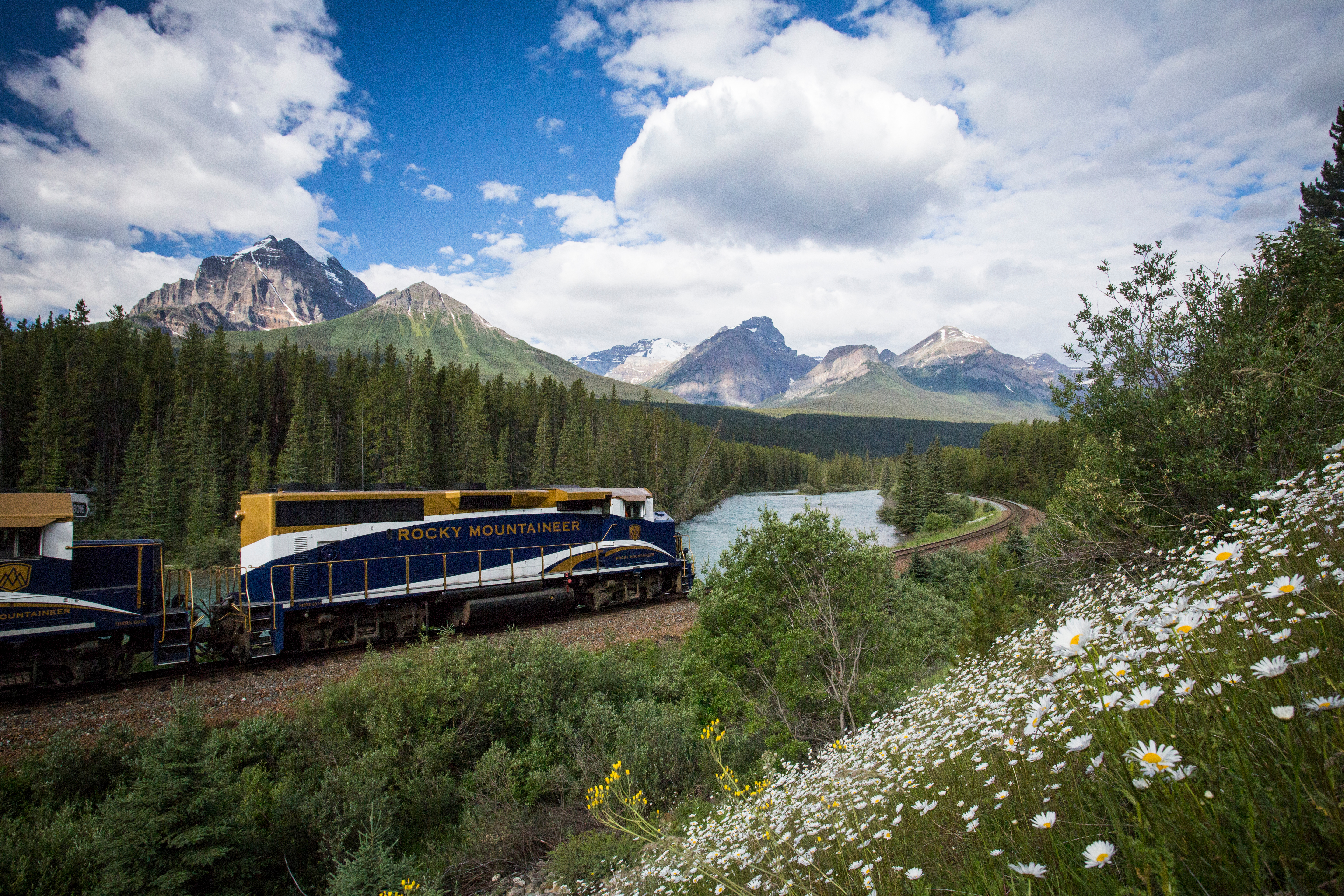 Rocky Mountaineer train going around a curve on the tracks