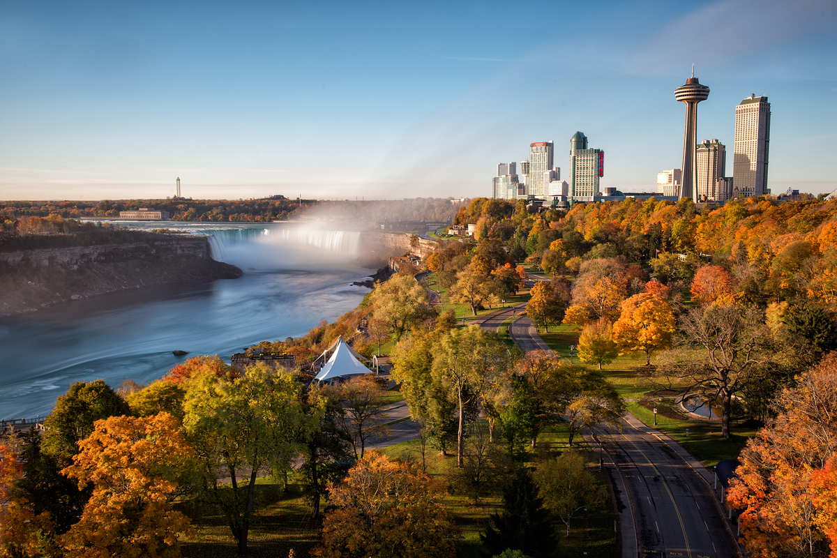Skyline of Niagara Falls waterfall and city during the autumn with lots of fall foliage around