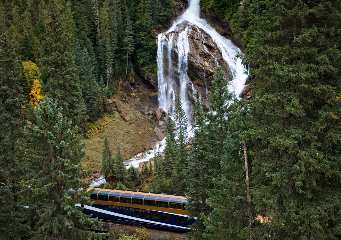 The Rocky Mountaineer train passing Pyramid Falls on the Journey Through the Clouds route.