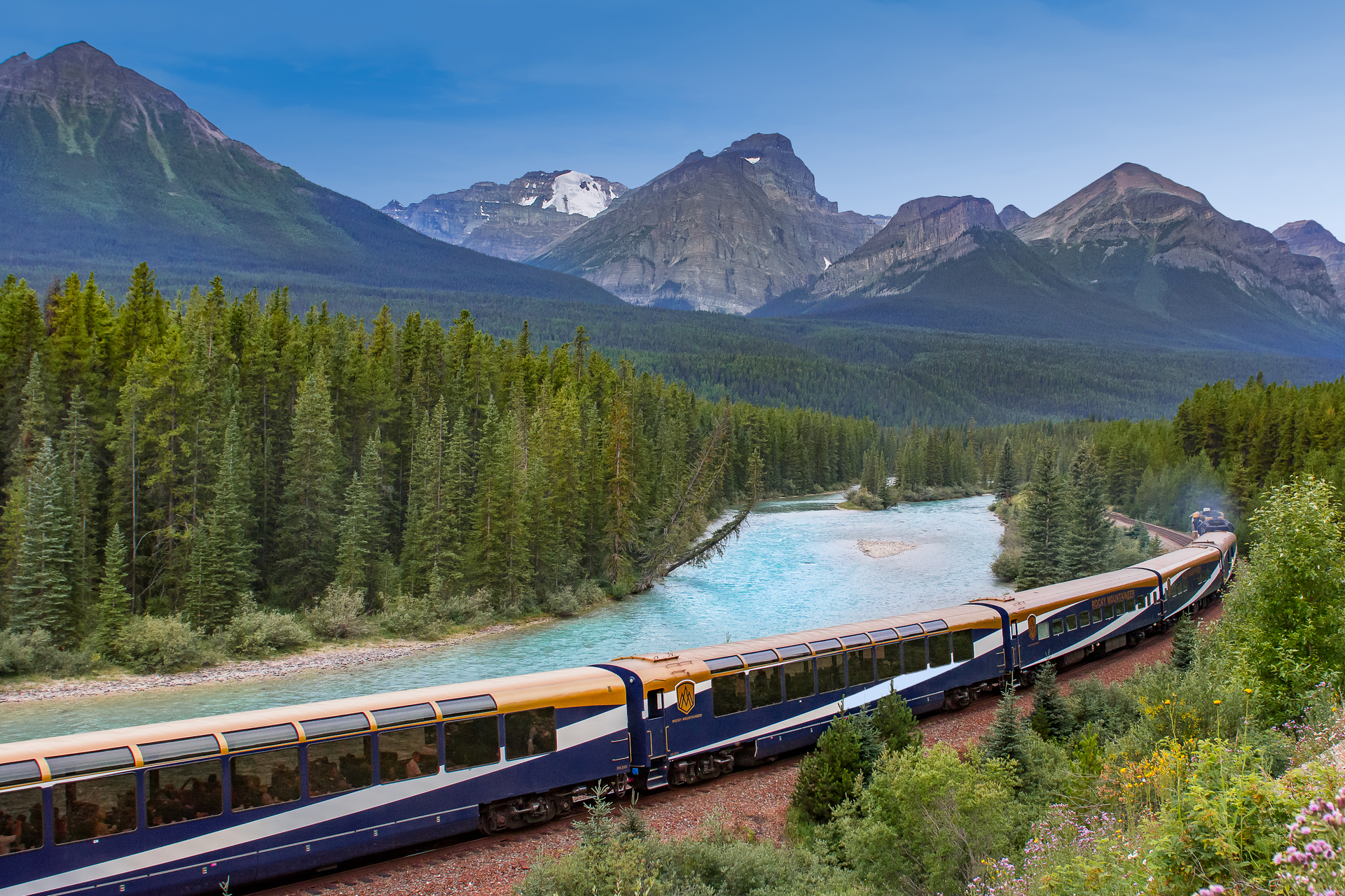 The Rocky Mountaineer train rounds Morant's Curve with the river and mountains in the background
