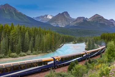 The Rocky Mountaineer train rounds Morant's Curve with the river and mountains in the background