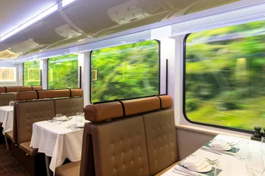 Interior of the gold leaf Rocky Mountaineer restoration train wagon and dining area while riding in British Columbia, Canada.