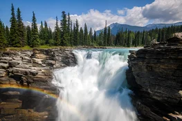 Water flows from gorge of river fed by glaciers of Columbia Icefield to powerful Athabasca Falls in Jasper National Park, Alberta, Canada