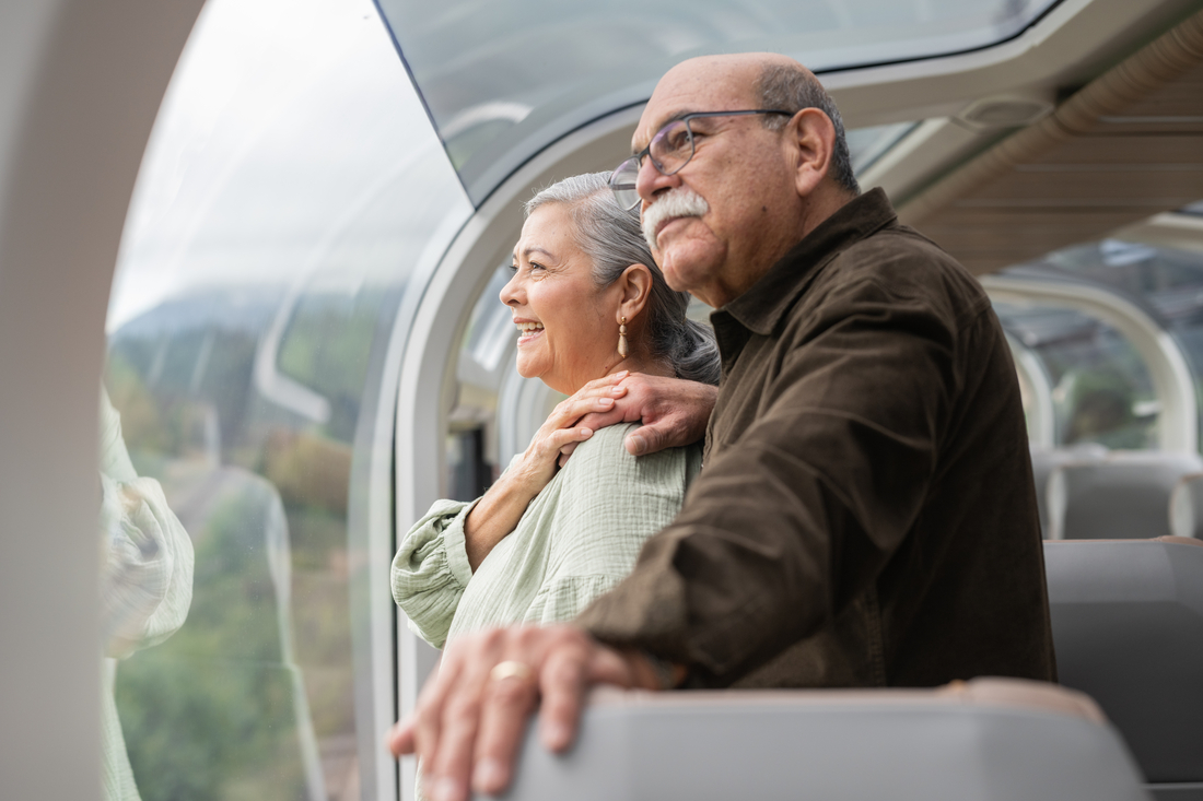 Guest looking at scenery from their seats in GoldLeaf on Rocky Mountaineer