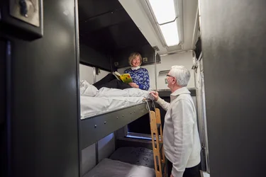 Couple preparing for overnight stay in cabin on VIA Rail train