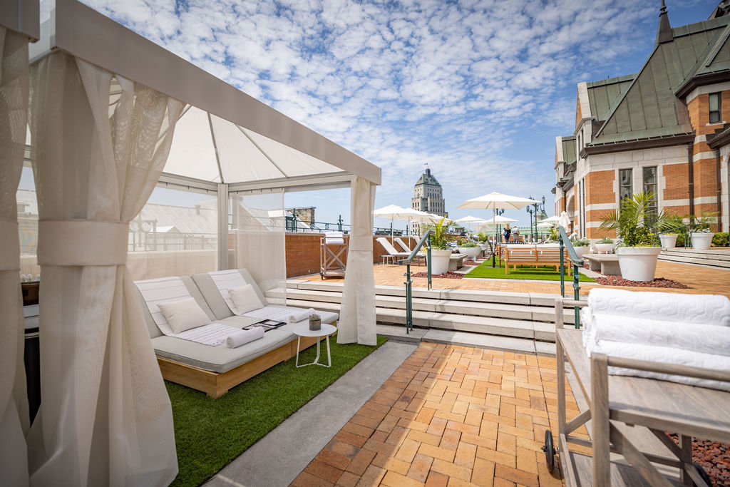 Cabanas and outdoor seating on the outdoor terrace of the Chateau Frontenac hotel in the summer