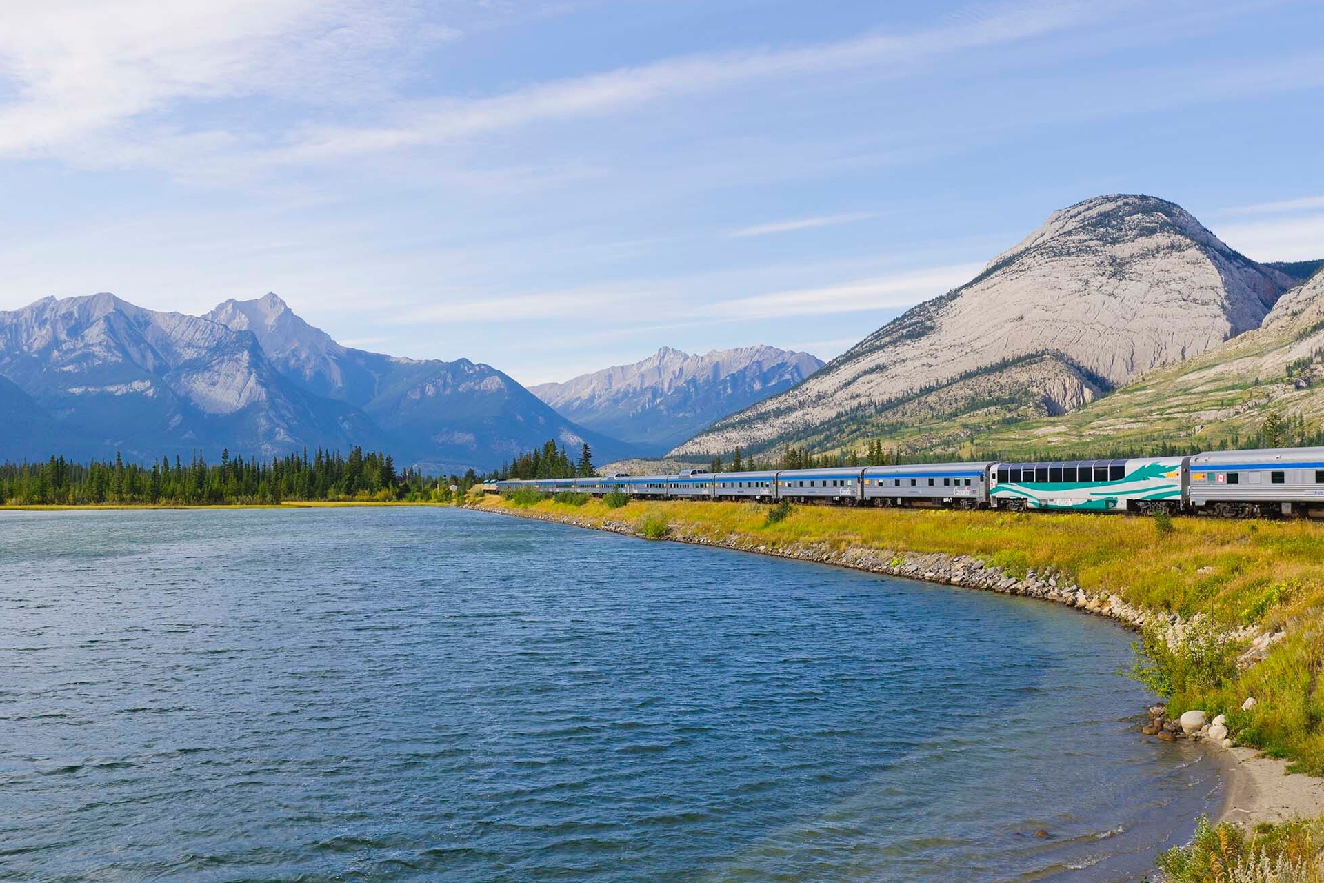 VIA Rail train with mountains in the background