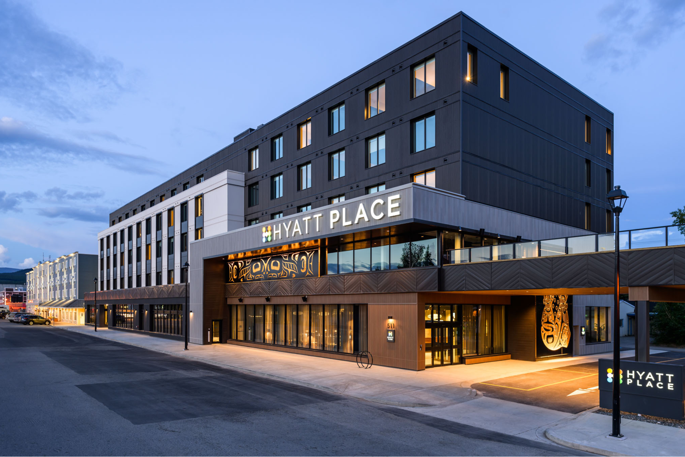 Exterior view of the modern Hyatt Place Hotel in Whitehorse during early evening