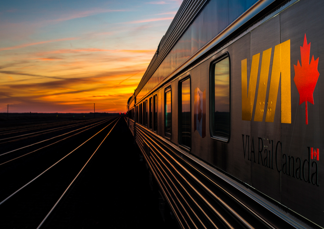 side view of a VIA Rail train at sunset