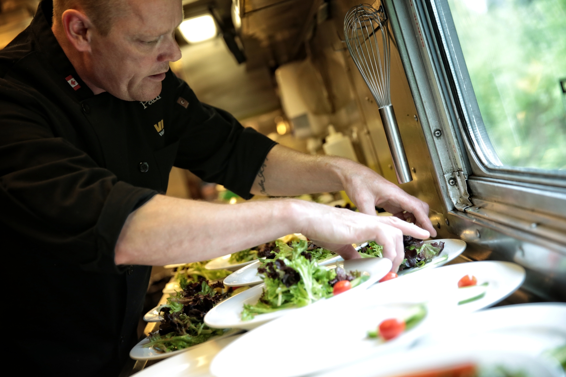Chef preparing meals in the kitchen of VIA Rail Canadian train 