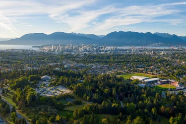 Aerial view of Queen Elizabeth park in Vancouver with the city and the mountains in the distance