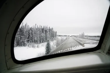 View from a train window going through snowy scenery during a winter trip.