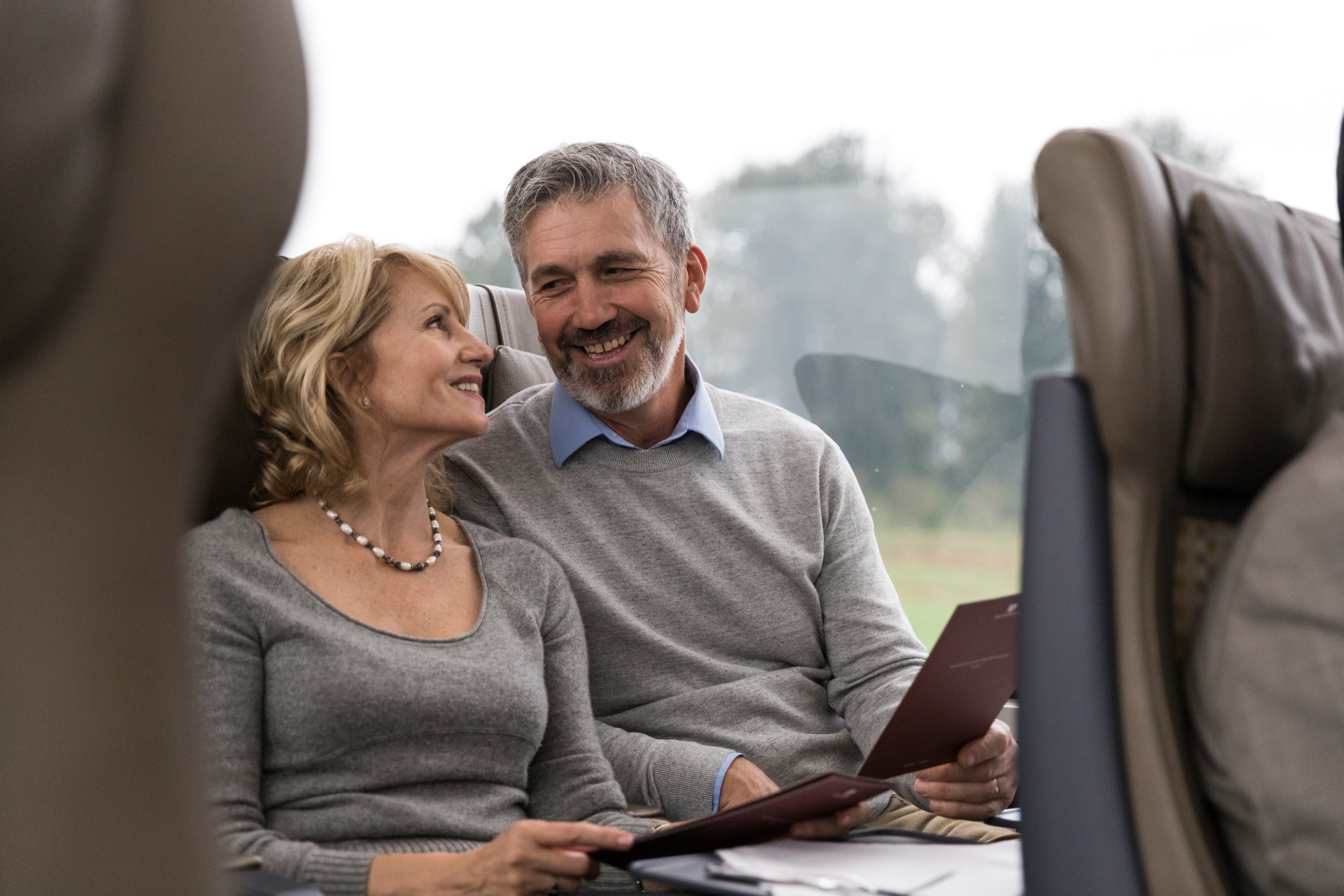 Couple sitting in SilverLeaf seats on the Rocky Mountaineer train 