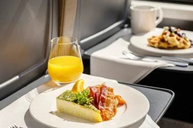 Breakfast dishes on SilverLeaf seat tray tables on the luxury Rocky Mountaineer train