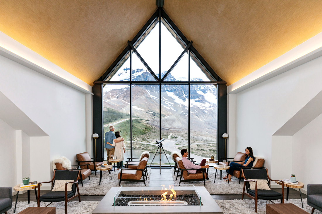 Lodge guests relaxing in lounge at Glacier View Lodge overlooking the Columbia Icefields