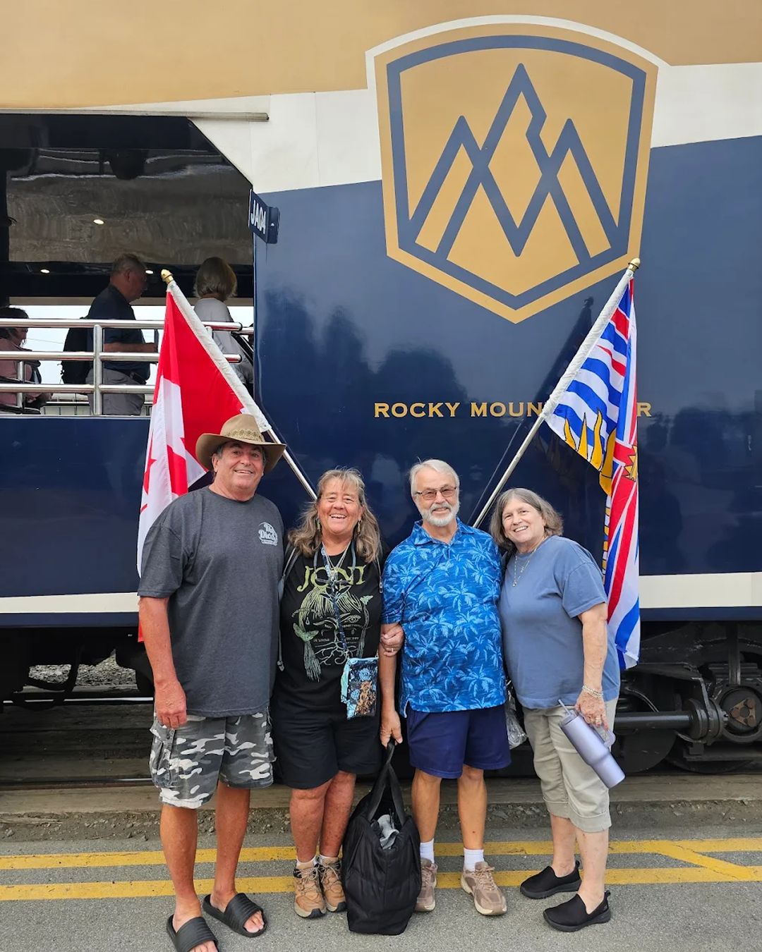 Group of 4 guests standing in front of the Rocky Mountaineer pre-departure