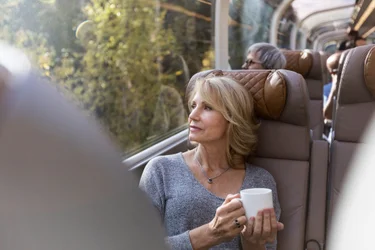 woman looking out of GoldLeaf glass-dome window on the Rocky Mountaineer train