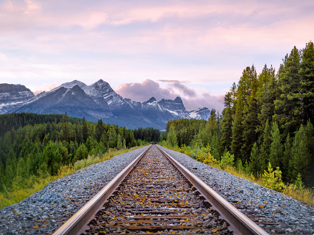 The Canadian Rockies, located between the Interior Plains of Alberta and the Rocky Mountain Trench of British Columbia, is a system of multiple mountain ranges which runs from the Canadian Prairies to the Pacific Coast.