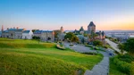 Quebec skyline with old buildings and spacious park with green lawn at dawn