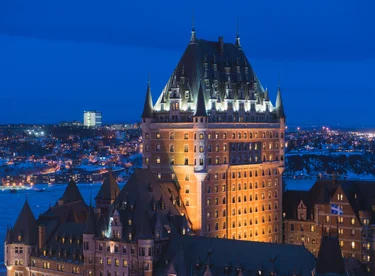 Fairmont Le Château Frontenac illuminated at night overlooking Quebec City.