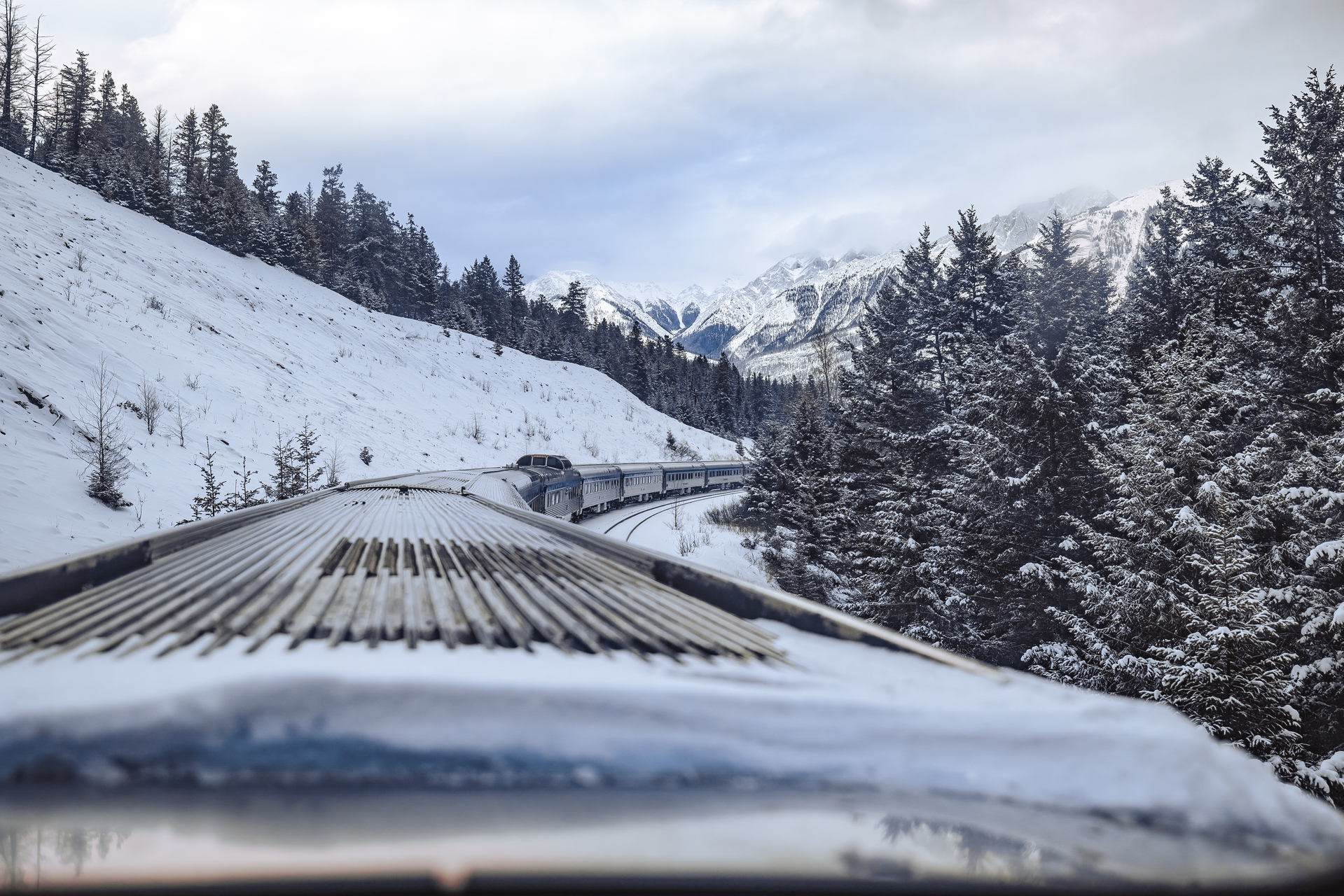 Top of VIA Rail's train, The Canadian, as it travels through snowy and mountainous landscape