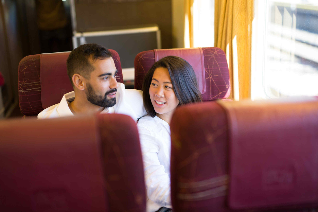 A man and woman seated on VIA rail's business service level. 