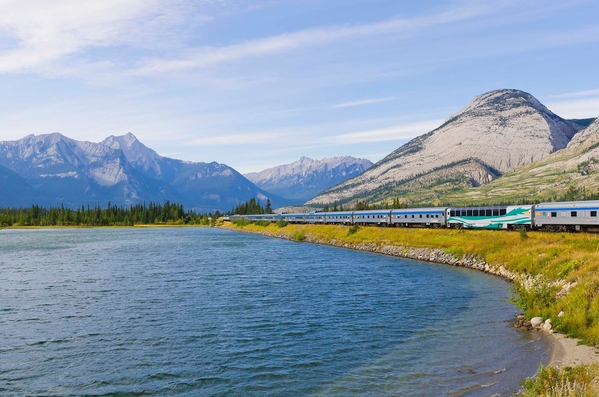VIA Rail train with mountains in the background