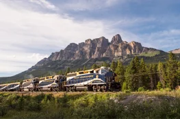 The Rocky Mountaineer train passing by Castle Mounain in the Canadian Rockies