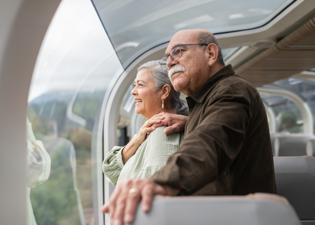 Guest looking at scenery from their seats in GoldLeaf on Rocky Mountaineer
