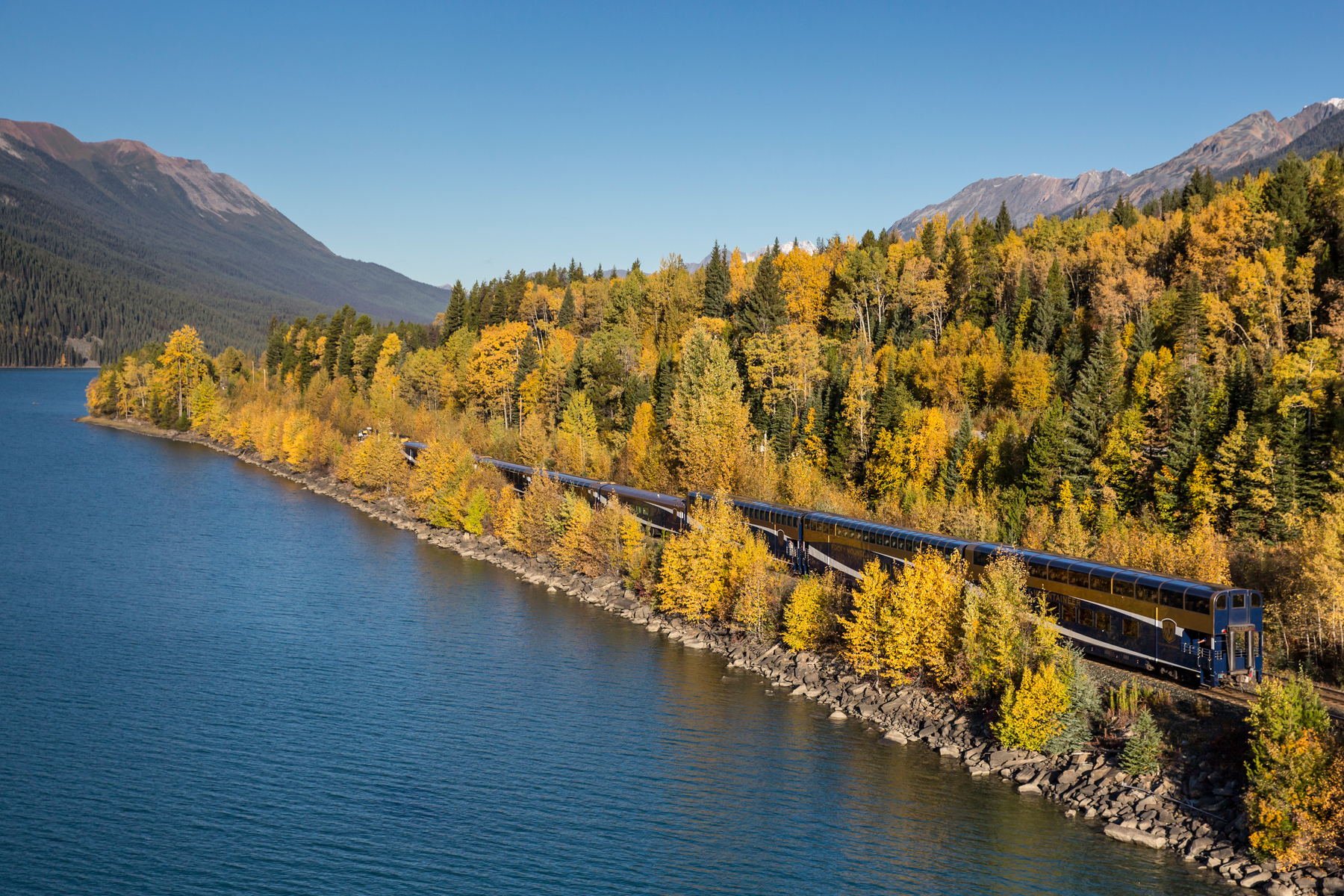 Exterior of Rocky Mountaineer train travelling past Moose Lake on the Journey through the Clouds route
