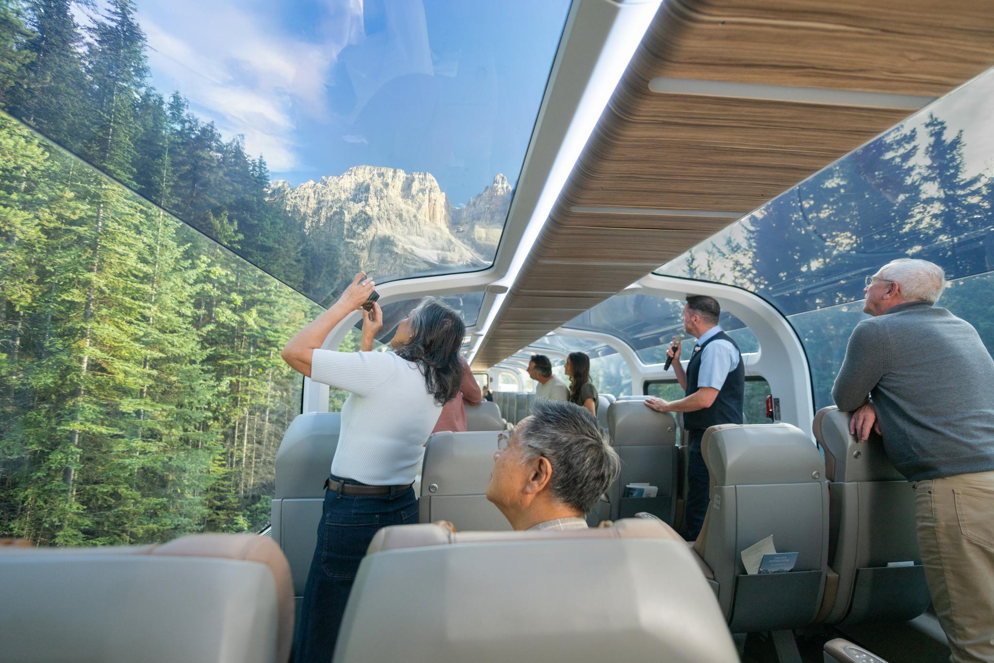 passengers enjoying the view on from Rocky Mountaineer GoldLeaf coach