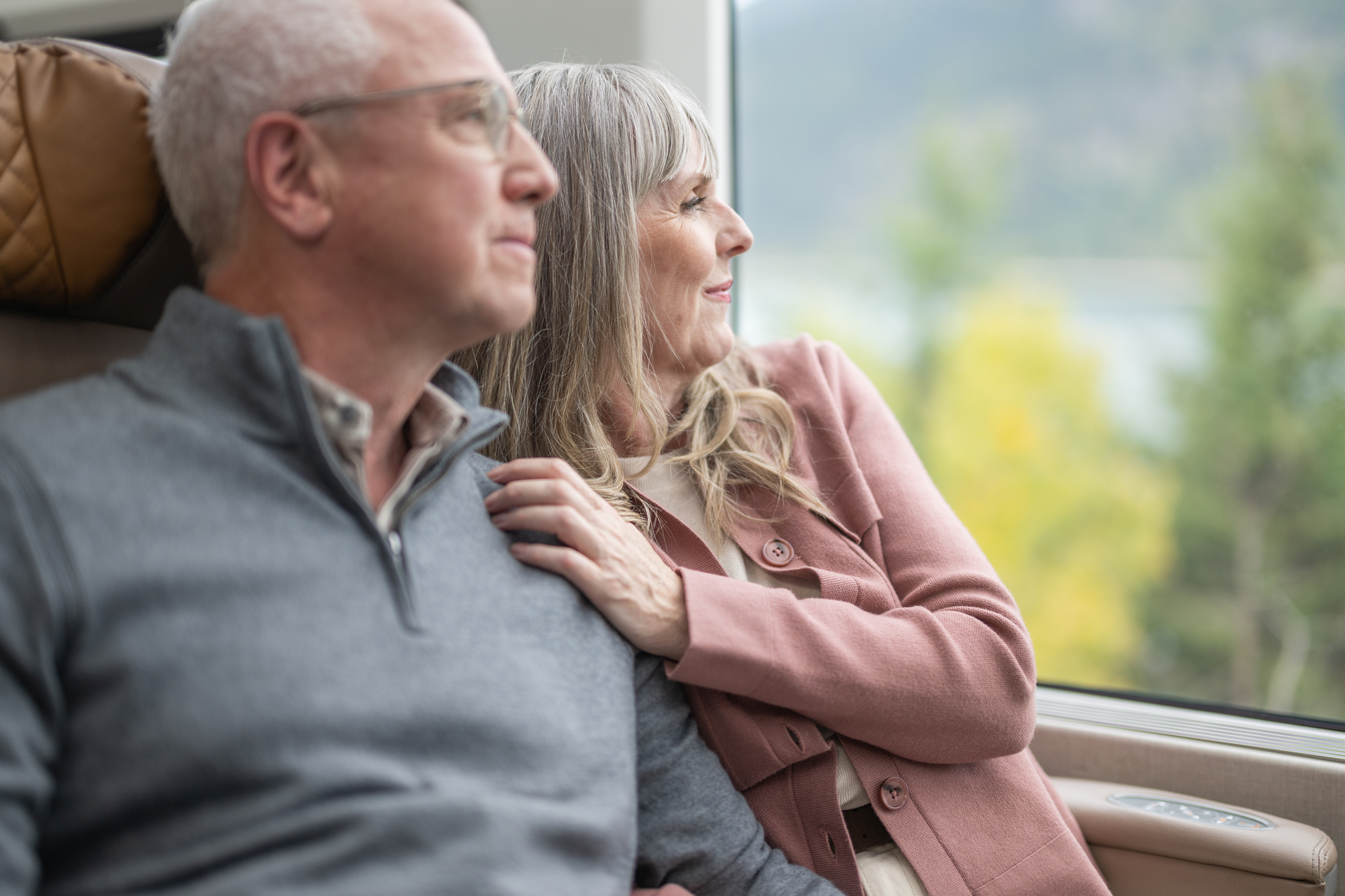Guests looking at scenery from their seats in GoldLeaf on the Rocky Mountaineer Train
