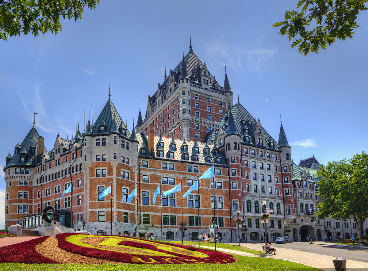 Chateau Frontenac historic hotel, castle architecture, with gardens out front