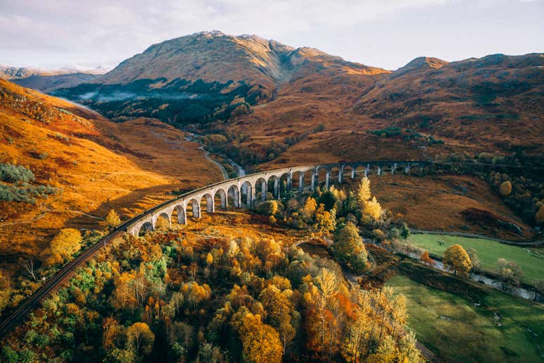 The Caledonian Sleeper crossing Glenfinnan Viaduct in the Scottish Highlands.