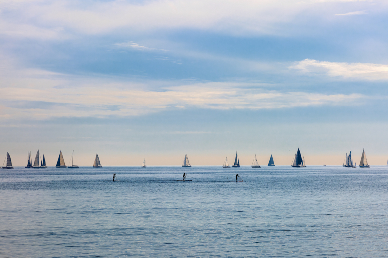 A view of sailboats on the Mediterranean Sea near Barcelona with a blue sky