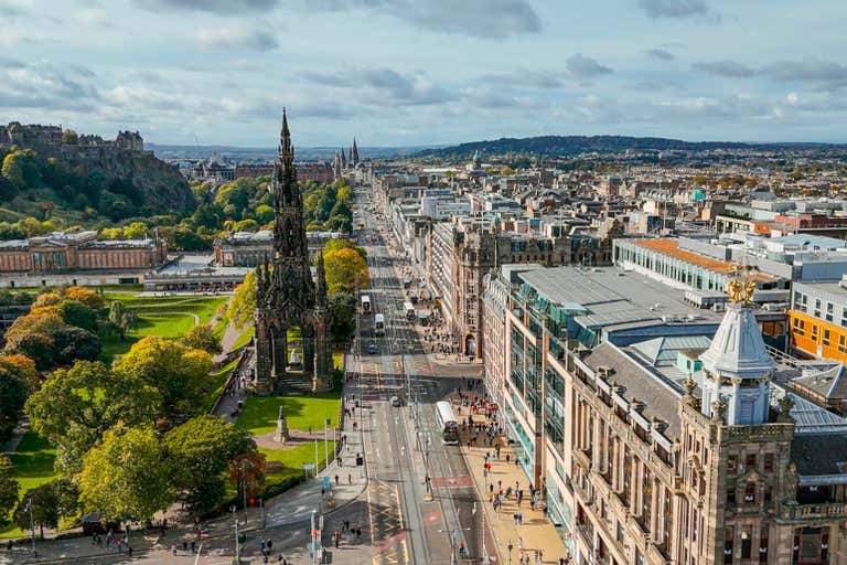 Aerial view of Princes Street in Edinburgh with the Scott Monument and surrounding buildings.