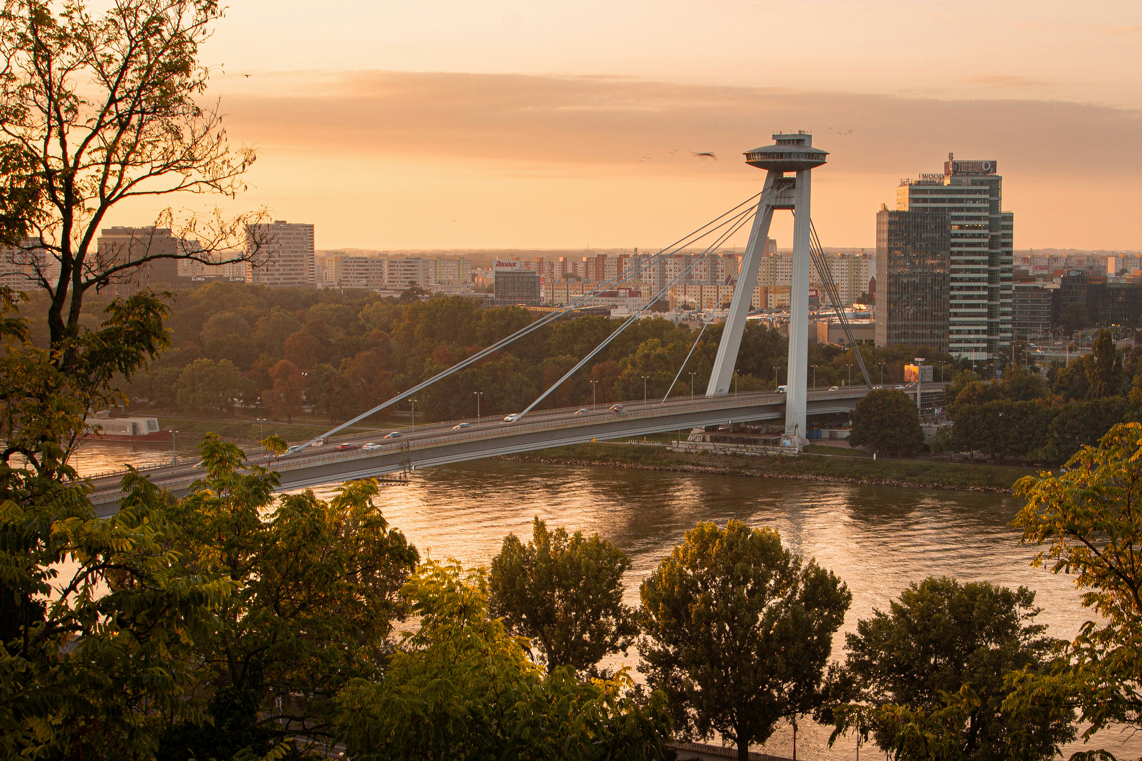 UFO Bridge spanning the Danube River in Bratislava at sunset.