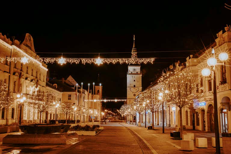 Quiet street in Slovenia at night with Christmas lights.