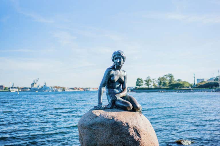 The iconic Little Mermaid statue perched on her rock in Copenhagen harbor, one of Denmark's most famous bucket-list attractions