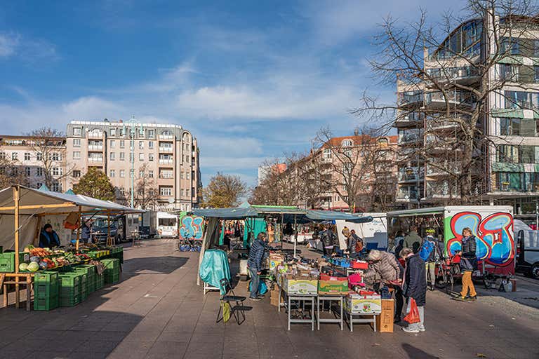 Winterfeldtplatz market in Berlin on a crisp winter morning, showing market stalls with fresh produce.